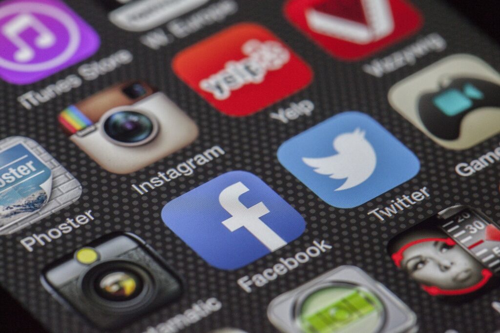 Social media and digital platform logos such as Facebook, Twitter, and Instagram, representing the role of big tech in the spread of information.