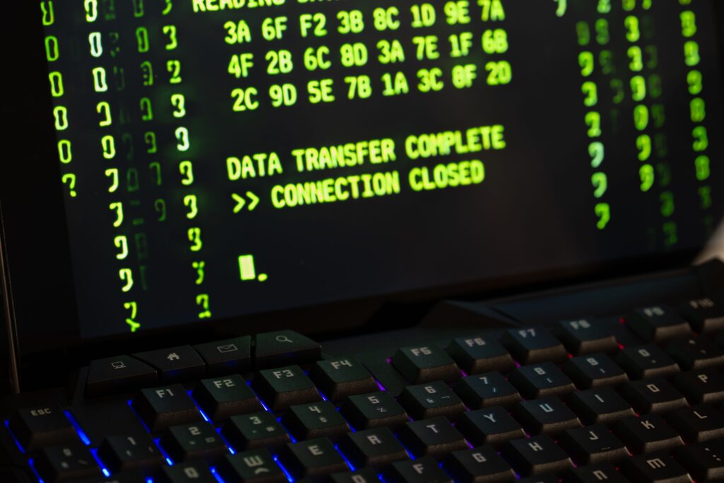 Computer screen displaying hexadecimal code and the message "data transfer complete, connection closed," symbolizing data surveillance and online scanning